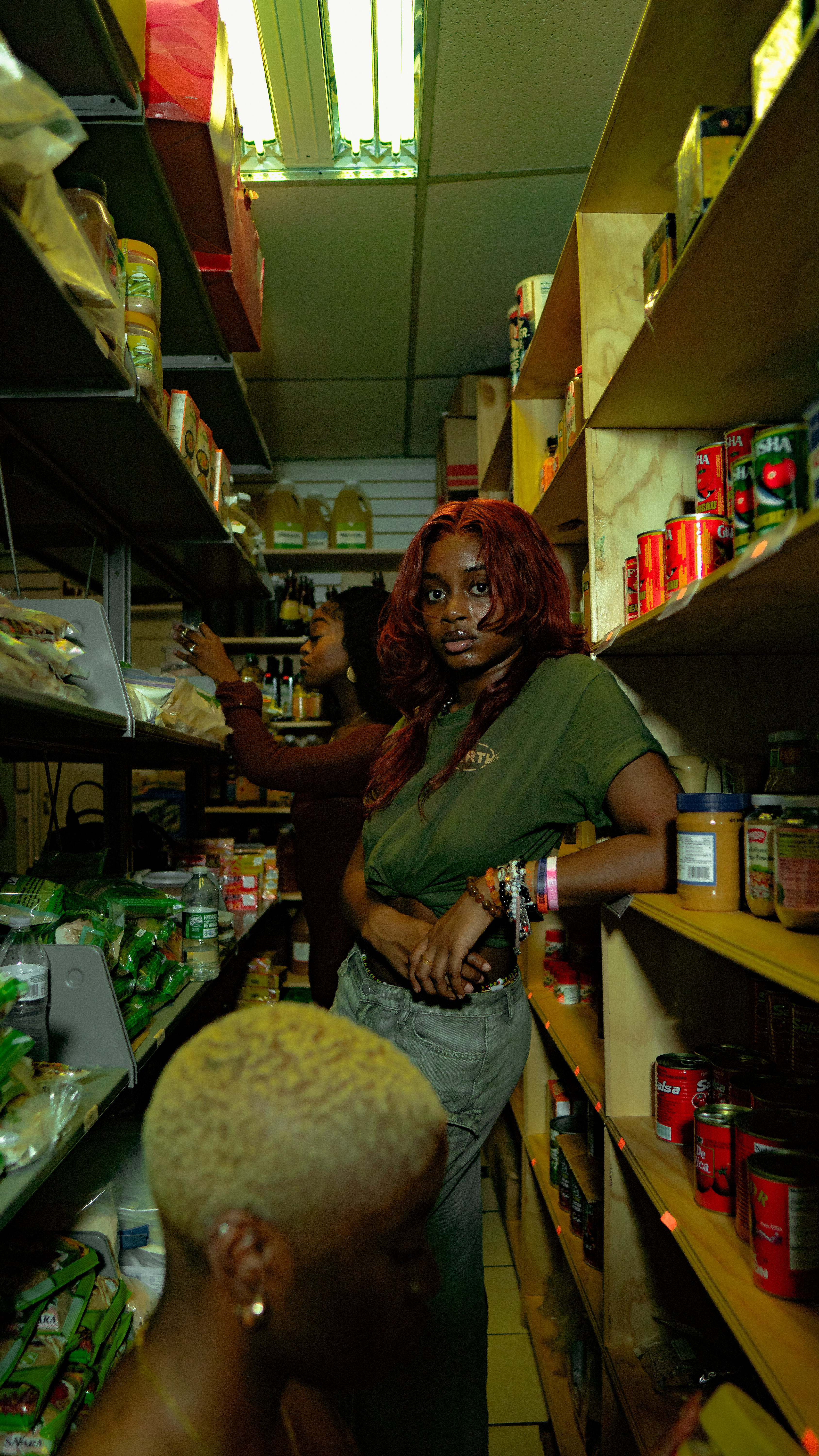 Portrait seated in aisle of African shop